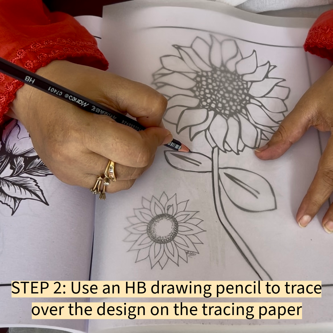 Use an HB drawing pencil to trace over the design on the tracing paper.