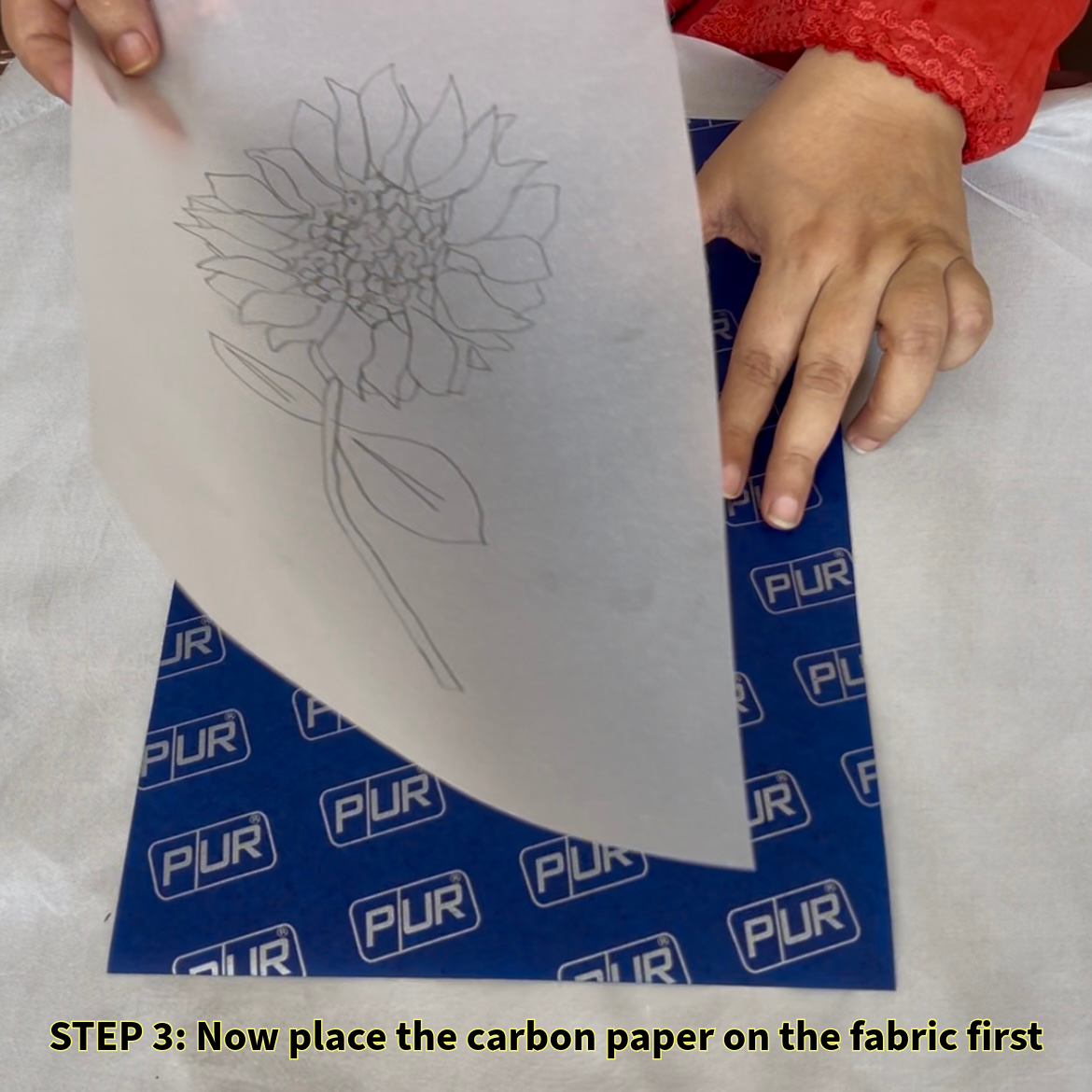 : Now place the carbon paper on the fabric first