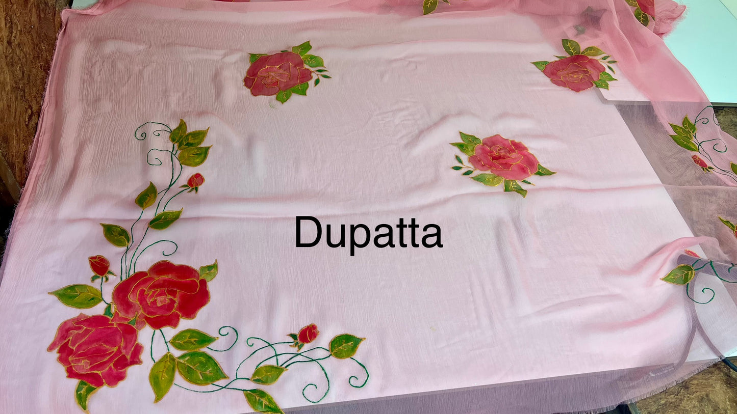 Pink dupatta with floral designs on a table